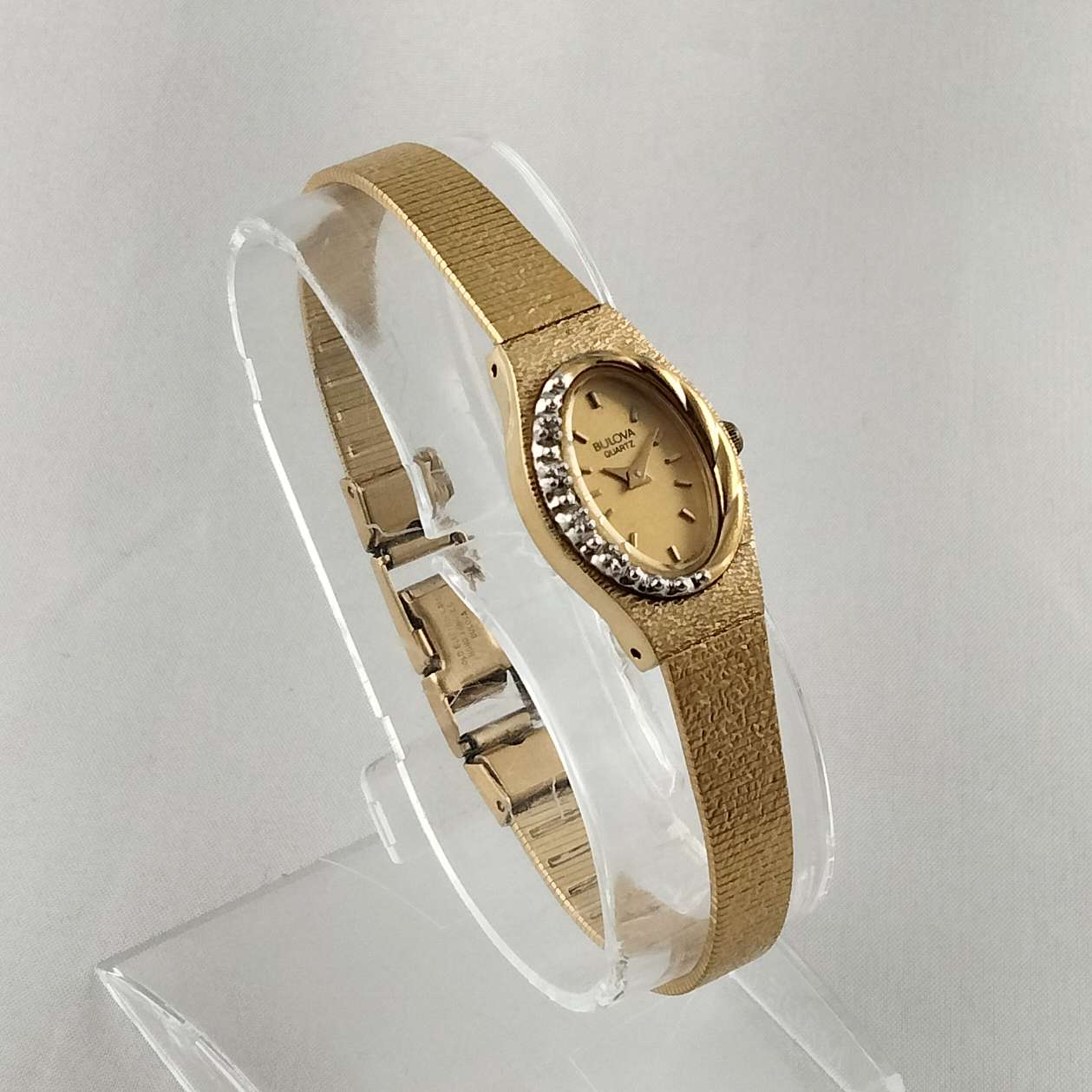 Bulova Quartz Petite Gold Tone Watch, Oval Dial, Asymmetrical Design, Smooth Bracelet Strap