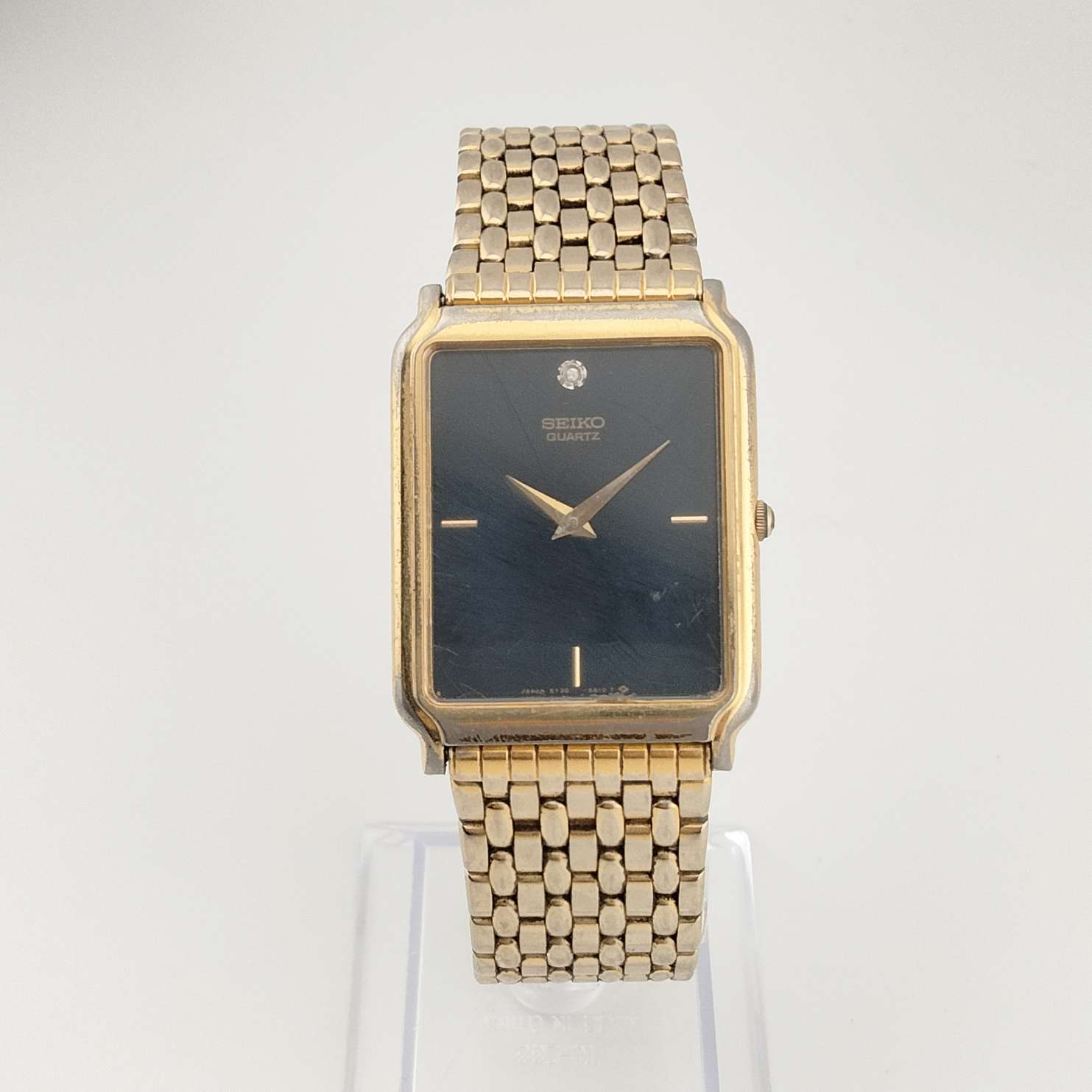 Seiko Men's Gold Tone Watch, Rectangular Black Dial, Jewel Detail, Bracelet Strap