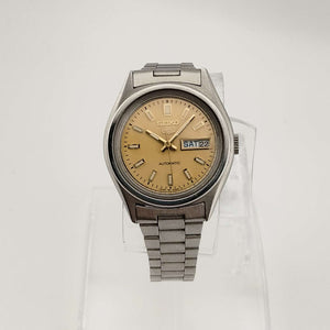 I Like Mikes Mid Century Modern Watches Seiko Unisex Silver Tone Watch, Circular Gold Tone Dial, Date and Day Window, Bracelet Strap