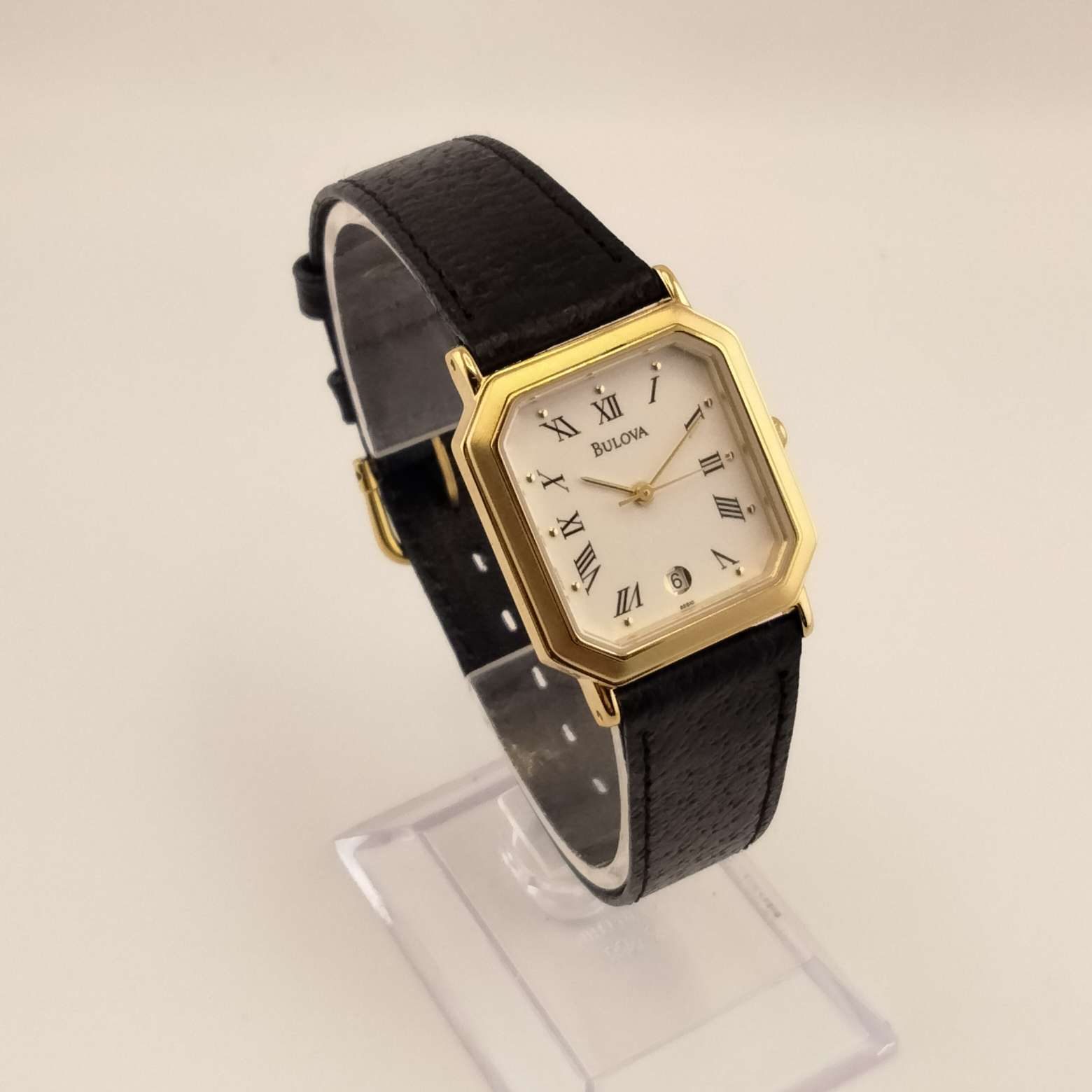 Bulova Watch, Gold Tone Accent on Octagon Dial, Raised Dot Hour Marks, Black Roman Numerals on a Cream Dial, Genuine Black Leather Strap