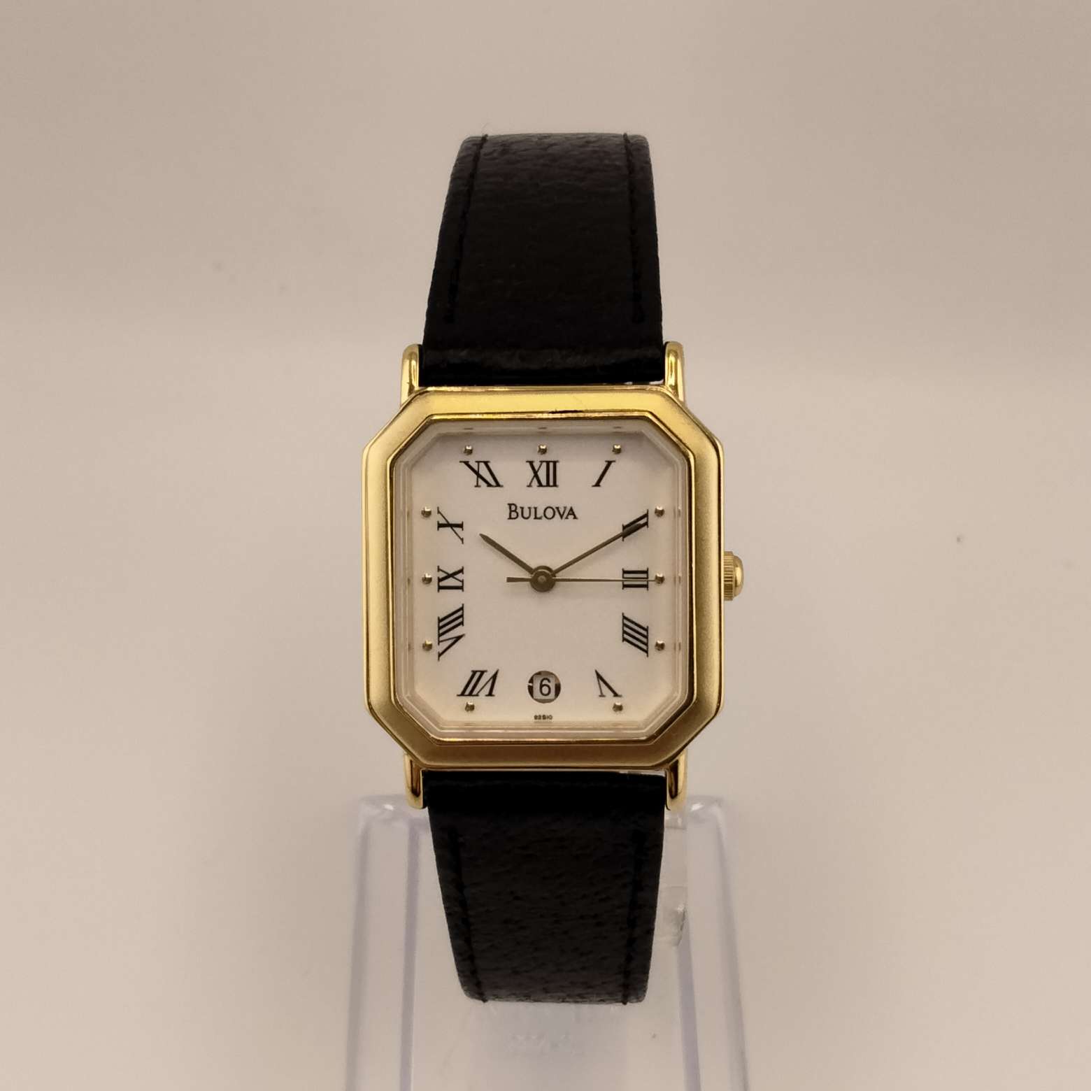 Bulova Watch, Gold Tone Accent on Octagon Dial, Raised Dot Hour Marks, Black Roman Numerals on a Cream Dial, Genuine Black Leather Strap